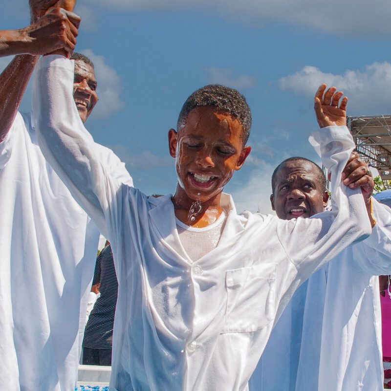 A boy smiles after being baptized