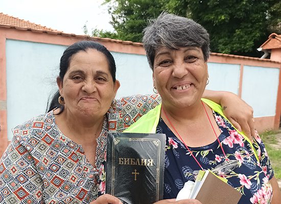 a woman in Eurasia happily receives a new Bible