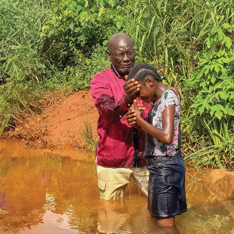 a young African girl is baptized